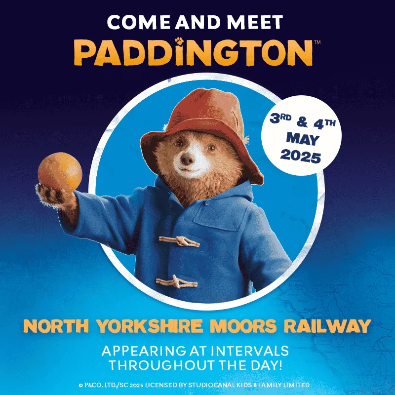 Paddington Bear offering an orange with text about his visit to NYMR on 3rd and 4th May